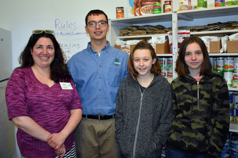 From left: Sarah Skovran, of the Area Interfaith Outreach Food Pantry; Jared Grenier, FoodCorps service member; and Medomak Middle School seventh graders Lillian Peirce and Angel Grierson inside Medomak Middle School's Community Market. (Alexander Violo photo)