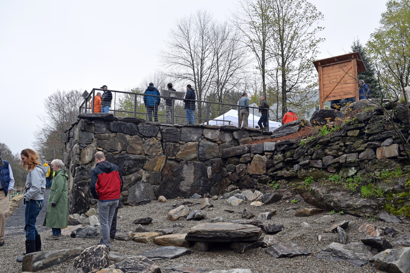 Visitors explore the former Coopers Mills Dam site after the dedication Monday, May 20. The base of the overlook incorporates stone from the dam. (Jessica Clifford photo)
