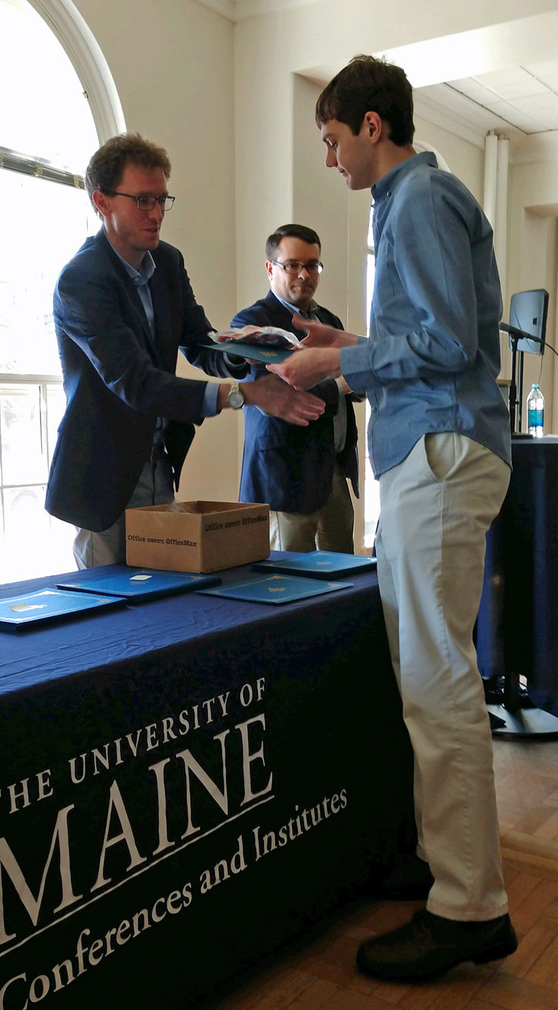 Taylor Holmes (right) is initiated into Phi Alpha Theta during a ceremony in the Estabrooke Ballroom at the University of Maine at Orono on April 29. Holmes is a 2018 graduate of Lincoln Academy.