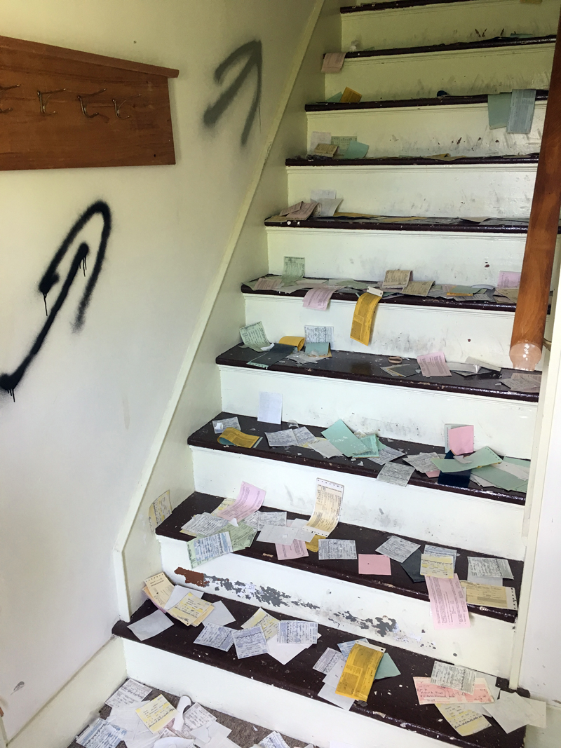 Arrows are spray-painted on the wall and papers strewn about at Alna's old town office. Police say two male juveniles burglarized the building and caused thousands of dollars in damage. (Photo courtesy Melissa Spinney)