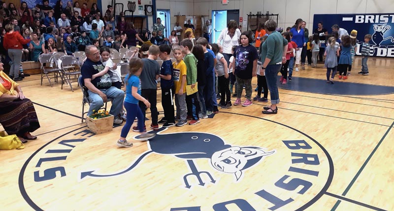 Hugs by the hundreds are given to Bob Onorato at his retirement from Bristol Consolidated School. Students lined up one grade at a time so that every one of them could give Onorato a goodbye hug. (Candy Congdon photo)