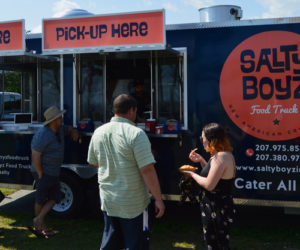 A crowd gathers in front of the Salty Boyz Food Truck at Popham Beach State Park in Phippsburg on Sunday, June 23. The truck will be open at Popham from 9 a.m. to 3 or 4 p.m. every day until Labor Day. (Evan Houk photo)