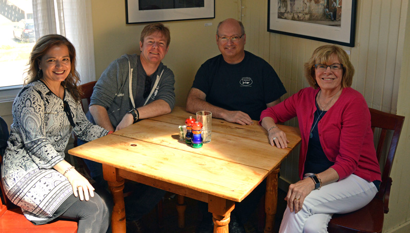 From left: The new owners of the Damariscotta River Grill, Tamara Dica and Tim Beal, sit with the Grill's founders, Rick Hirsch and Jean Kerrigan, at a corner table of the restaurant. Beal and Dica say nothing will change at the Grill, which will reopen for business as usual Thursday, June 13. (Evan Houk photo)