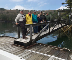 Volunteers and staff from Coastal Rivers Conservation Trust and the Maine Bureau of Parks and Lands made short work of installing the dock at Dodge Point on May 21. The reconstructed pier can be seen in the background. From left: Steve Spencer, Matt Filler, Chet Killam, Kim Lynch, Jesse Ferreira, Jim Grenier, and Glenn Kessler. (Photo courtesy Joy Vaughan)