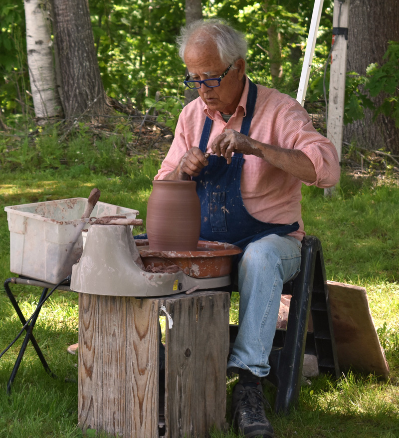 McCabe Coolidge, a potter based in South Thomaston, works at the Waldoboro Farmers Market on Saturday, June 22. (Alexander Violo photo)