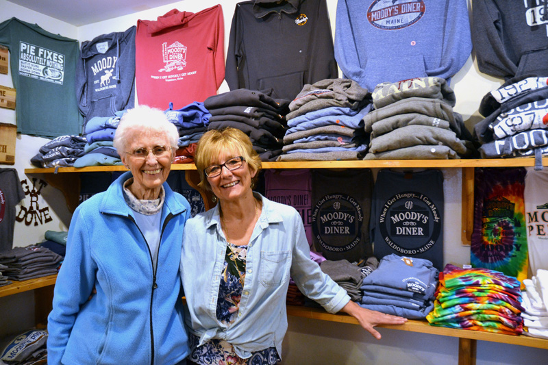 Moody's Gifts owners Nancy Genthner and Mary Olson stand in front of a display of Moody's Diner T-shirts at their Waldoboro shop. The mother-and-daughter duo started the shop with their husbands more than 20 years ago. (Maia Zewert photo)