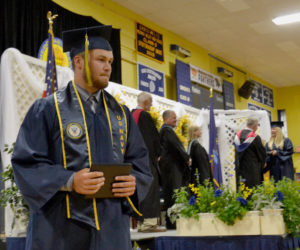 Kevin White returns to his seat after receiving his diploma during Medomak Valley High School's graduation ceremony Wednesday, June 12. (Maia Zewert photo)