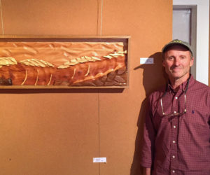 Artist Carl Solberg, of Waldoboro, stands next to one of his wood sculptures currently on exhibit at the Maine Coastal Islands NWR Visitor Center, 9 Water St. in Rockland. Solberg will talk about his work on Wednesday, July 10 at 6:30 p.m. The exhibit runs through July 19.