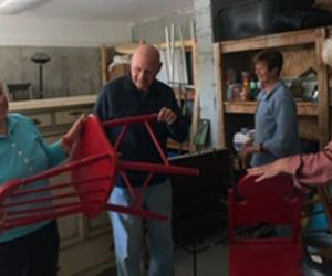 From left: Summer fair committee members Karen Hammond, Roger Sandler, Priscilla House, and Donna Plummer get ready for the gigantic yard sale.