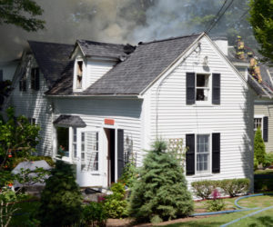 Firefighters attack a house fire from both sides at 26 Logan Road in Boothbay Harbor the morning of Tuesday, July 16. (Evan Houk photo)