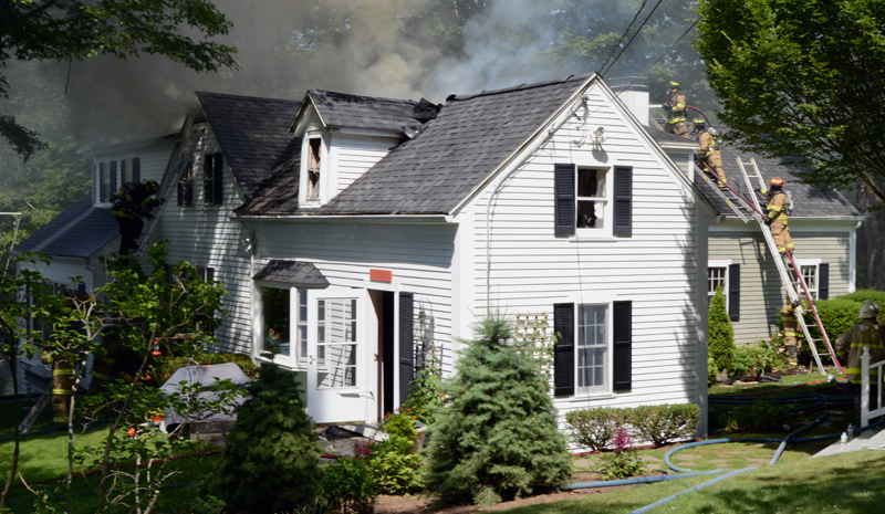 Firefighters attack a house fire from both sides at 26 Logan Road in Boothbay Harbor the morning of Tuesday, July 16. (Evan Houk photo)