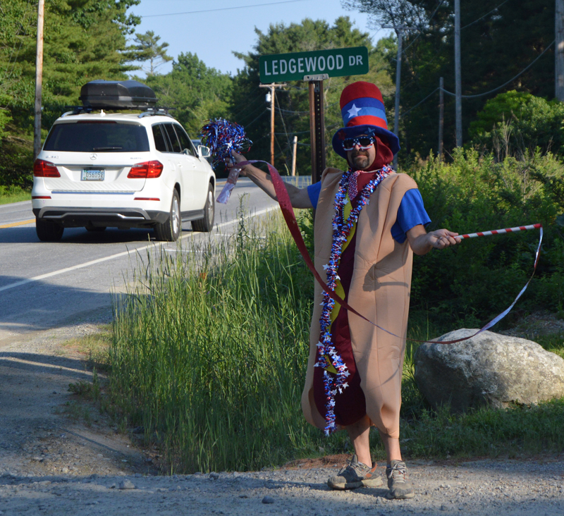 "Hot Dog Man" attempts to entice passersby to stop for the annual hot dog-eating contest at Stackhouse Landscaping in Bristol Mills on July 3. The event pays for scholarships to send kids to summer camp. (Evan Houk photo)