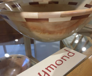 Wood artist Tom Raymond's bowl, made from box elder from his yard, graces a display stand at Saltwater Artists Gallery in Bristol. (Christine LaPado-Breglia photo)