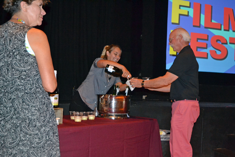 Laurel Gallione (center) serves an attendee at the opening-night reception of the inaugural MidCoast Film Fest on the evening of Friday, July 26. (Christine LaPado-Breglia photo)