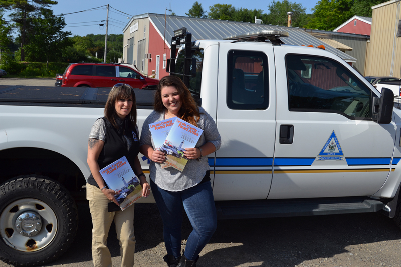 Melissa Temple, deputy director of the Lincoln County Emergency Management Agency, and Maia Zewert, marketing and engagement coordinator for Lincoln County Publishing Co., hold copies of the 2019 Lincoln County Road Atlas. (John Roberts photo)