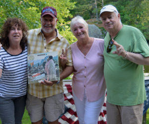 Mill Pond Inn co-owners Sherry (far left) and Bobby (far right) Whear flash peace signs with guests Nick and Bobbi Ercoline as Nick holds the Woodstock concert album, which features a photo of the Ercolines embracing. The famous music festival was 50 years ago this August. (Evan Houk photo)