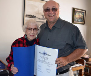 State Sen. Dana Dow presents May Davidson a legislative sentiment at her Whitefield home on Thursday, July 25 in honor of her recent 90th birthday and her new book, "Whatever It Takes: Seven Decades of True Love, Hard Work, and No Regrets," published by Islandport Press. (Christine LaPado-Breglia photo)