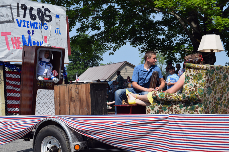 A float celebrates the 50th anniversary of the 1969 moon landing during the Fourth of July parade in Whitefield. The float depicts people in period dress watching the event on TV. (Jessica Clifford photo)