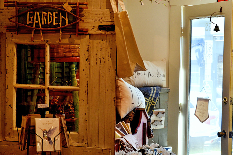 The original barn door from the Old and Everlasting shop in Cazenovia, N.Y. serves as a prop for merchandise in the Wiscasset shop. (Nettie Hoagland photo)