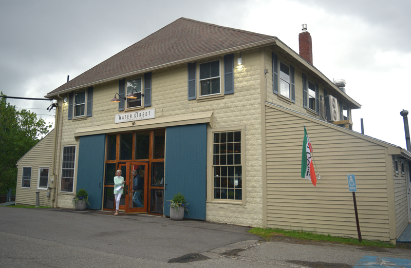 Patrons exit Water Street Kitchen and Bar, a new restaurant in the former location of Le Garage, at 15 Water St. in Wiscasset. (Jessica Clifford photo)
