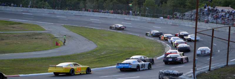 Drivers take a hard turn in the 50-lap prostock feature race during Wiscasset Speedway's 50th anniversary event Saturday, July 27. Kevin Douglass, of Sidney, won the race. (Evan Houk photo)