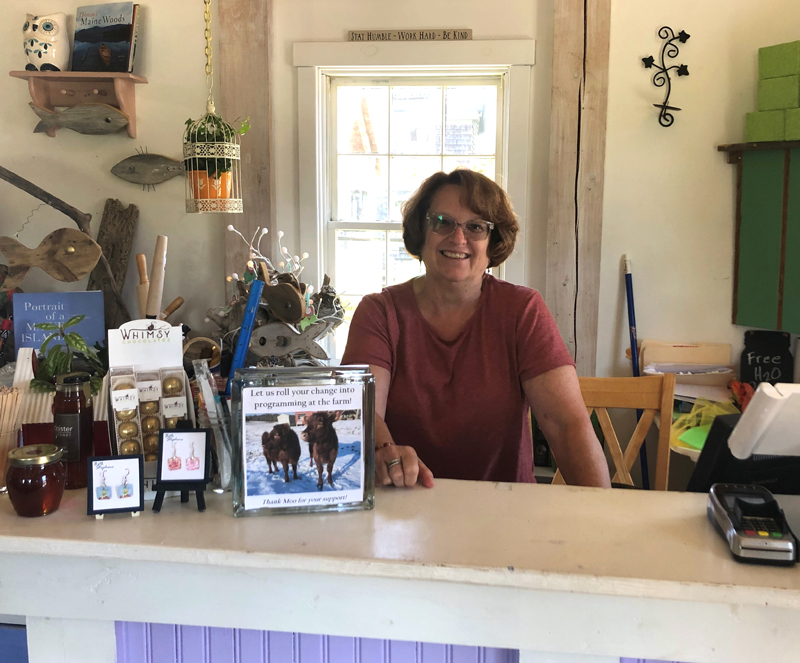 Board member and store volunteer Lori Bryant stands behind the counter of the Morris Farm Store.