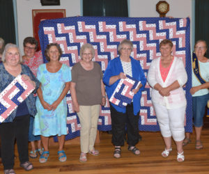 Willow Grange in Jefferson presents Lincoln County Quilters with a Spirit of America Award for their Quilts of Gratitude project. Willow Grange presented Lincoln County Quilters with a quilt top for their project. Seven members of the quilting group were on hand to receive the award. Also pictured (holding the quilt top) are Grange members Karen McCarrick and Linda Cunningham. (Paula Roberts photo)