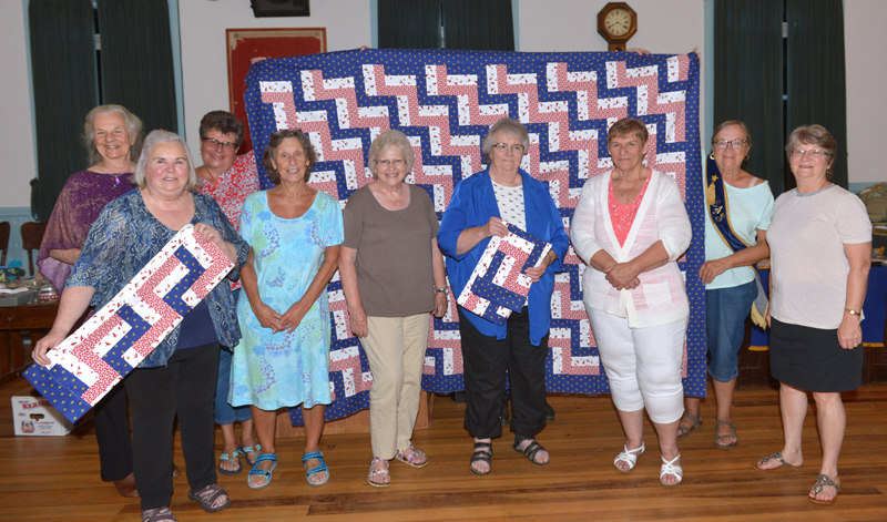 Willow Grange in Jefferson presents Lincoln County Quilters with a Spirit of America Award for their Quilts of Gratitude project. Willow Grange presented Lincoln County Quilters with a quilt top for their project. Seven members of the quilting group were on hand to receive the award. Also pictured (holding the quilt top) are Grange members Karen McCarrick and Linda Cunningham. (Paula Roberts photo)