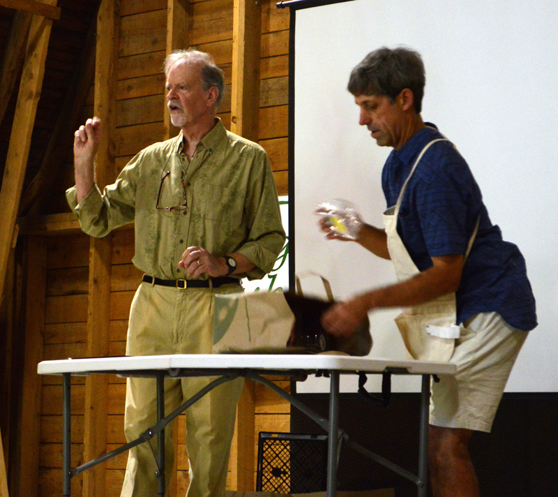 Michael Uhl (left) and Mark Ward display various items and discuss whether they are recyclable during their "Talking Trash!" community forum at Darrows Barn in Damariscotta on Thursday, Aug. 22. (Evan Houk photo)