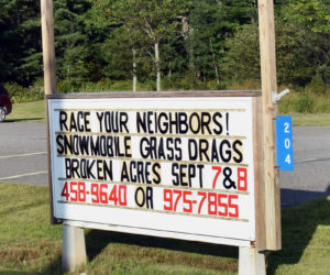 A sign at the Jefferson fire station advertises upcoming snowmobile "grass drags" at Broken Acres Family Retreat. The sport is growing in popularity, according to organizers. (Alexander Violo photo)