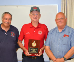 Damariscotta Deputy Fire Chief James "High Speed" Hall accepts the Chief Bob Maxcy Lifetime Achievement Award from the Lincoln County Fire Chiefs Association as President Roger Whitney (left) and Vice President Paul Leeman Jr. look on. (J.W. Oliver photo)