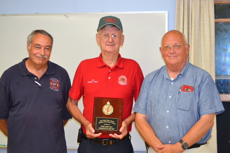 Damariscotta Deputy Fire Chief James "High Speed" Hall accepts the Chief Bob Maxcy Lifetime Achievement Award from the Lincoln County Fire Chiefs Association as President Roger Whitney (left) and Vice President Paul Leeman Jr. look on. (J.W. Oliver photo)