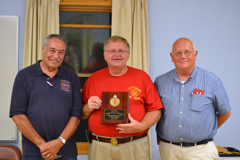 Jefferson Fire Chief Walter "Wally" Morris accepts the Past President's Award from Lincoln County Fire Chiefs Association President Roger Whitney (left) and Vice President Paul Leeman Jr. (J.W. Oliver photo)