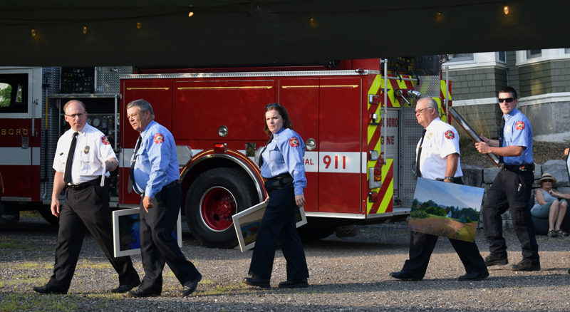 Members of the Waldoboro Fire Department assist with the evening's auction at Paint the Town, Waldoboro. (Alexander Violo photo)