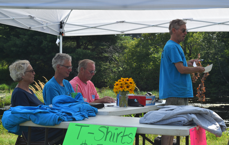 Clary Lake Association Secretary George Fergusson addresses members at the annual meeting Sunday, Aug. 4, as association officers, from left, Mary Gingrow-Shaw, Malcolm Burson, and David Knight look on. (Jessica Clifford photo)