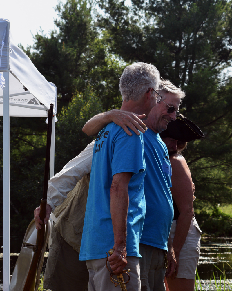 Clary Lake Association Secretary George Fergusson wraps his arm around former association President Malcolm Burson after giving him a dramatic thank you for his ongoing dedication to the association and knighting him as Sir George of Clary - Lake Keeper for Life. (Jessica Clifford photo)