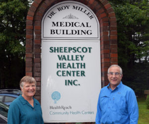 Lisa and Dr. Roy Miller stand next to the new sign for the Dr. Roy Miller Medical Building in Coopers Mills. The Sheepscot Valley Health Center Board of Directors renamed the building in honor of the center's first physician and his 38 years of service. (Jessica Clifford photo)