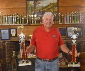 Jack Studley holds two 2018 point series championship trophies. The mantel of Jack and Grayce's 1791 Hall House in Nobleboro is loaded with trophies he has won pulling tractors at Maine fairs. (Paula Roberts photo)