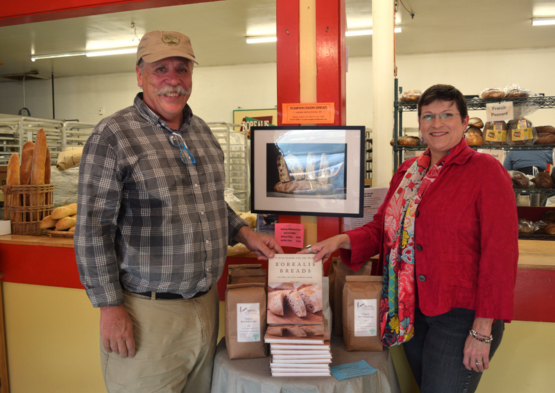 Borealis Breads owner Jim Amaral, of Alna, and food writer Cynthia Finnemore Simonds, of Newcastle, display their new book, "Borealis Breads: 75 Recipes for Breads, Soups, Sides, and More," at Borealis Breads in Waldoboro. (Jessica Clifford photo)