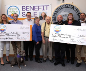 The family behind Oranges from Morgan presents $15,000 checks to Healthy Lincoln County and the Midcoast Recovery Coalition at the Damariscotta town office Friday, Sept. 6. From left: Jess Breithaupt, of Healthy Lincoln County; Derek Mayo, with Marley; Joe Mayo; Florence and Ernest Bourgon; Damariscotta Police Chief Jason Warlick; Tamra Mayo; and Dr. Ira G. Mandel, of the Midcoast Recovery Coalition. (Photo courtesy John Maciel)