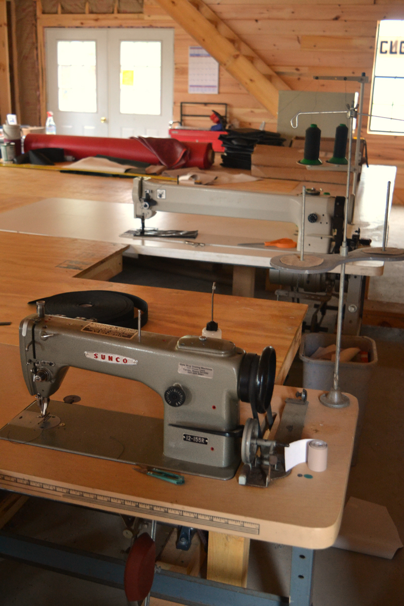 The industrial sewing machines at Benjamin Zook's Cooper Canvas shop in Whitefield. The machine at rear measures a yard across. (Christine LaPado-Breglia photo)