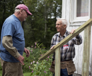 Stephen Busch (left) and Bill Schwanemann discuss how to install a railing on a new set of stairs at Skyview Ridge Mobile Home Park in Waldoboro on Community Cares Day, Sunday, Sept. 8. (Jessica Picard photo)
