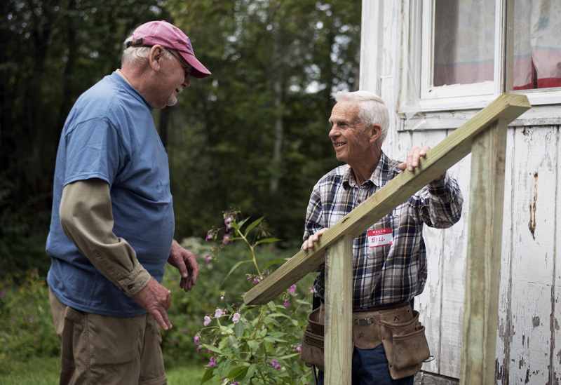 Stephen Busch (left) and Bill Schwanemann discuss how to install a railing on a new set of stairs at Skyview Ridge Mobile Home Park in Waldoboro on Community Cares Day, Sunday, Sept. 8. (Jessica Picard photo)