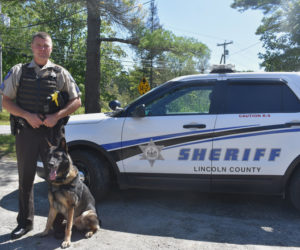 Lincoln County Sheriff's Office Sgt. Kevin Dennison and Duke stand next to their cruiser. Dennison was promoted to patrol sergeant in June. (Jessica Clifford photo)