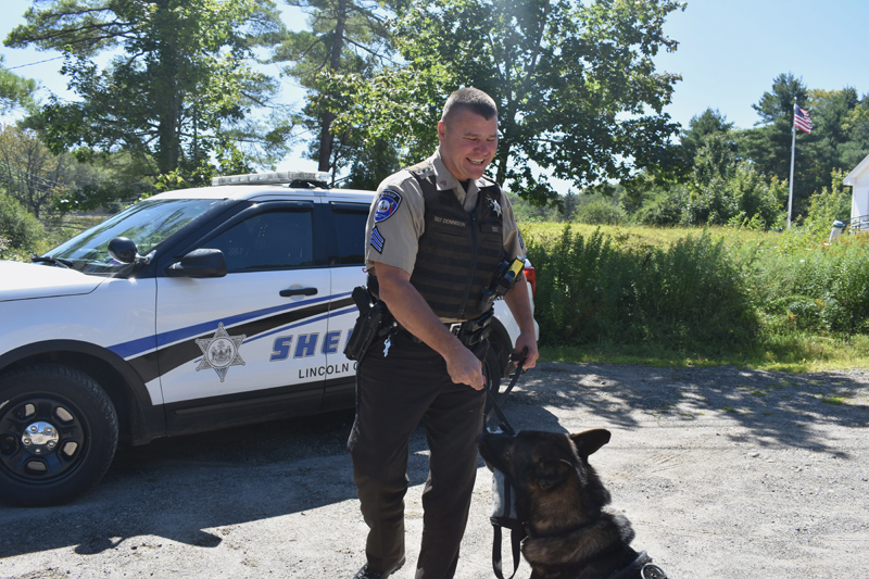 Sgt. Kevin Dennison rewards his K-9 partner, Duke, with a toy. (Jessica Clifford photo)