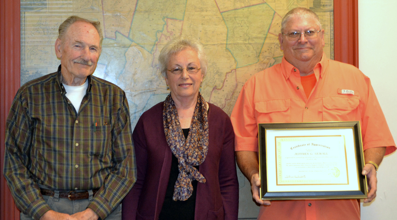 From left: Daniel Davey, Laurinda Cushman, and Jeffrey Sewall at the Lincoln County Board of Commissioners meeting Tuesday, Sept. 17. Daniel Davey and Cushman are the brother and widow of Lincoln County Sheriff's Office Detective Sgt. Donald Davey, who died in a crash while on duty July 30, 1984. Sewall, a former sheriff's deputy, responded to the crash. (Charlotte Boynton photo)