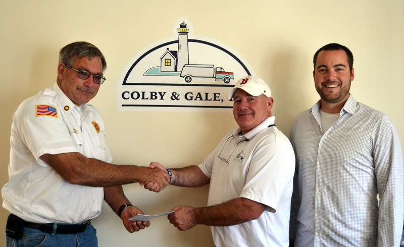 Boothbay Fire Chief Dick Spofford (left) accepts a check from Colby & Gale Inc. Manager Troy Sawyer and CEO Matt Poole. Colby & Gale Inc.Â’s recent benefit raffle of a seasonÂ’s worth of fuel oil or propane raised more than $10,000 for the Boothbay Fire Department.