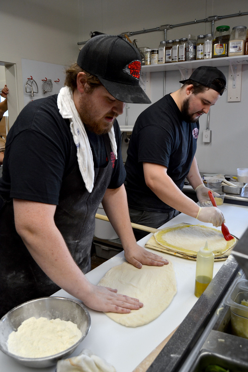 Tyler Wedge (left) and Gavin Hayford make pizza at Oysterhead Pizza Co. in Damariscotta the afternoon of Friday, Oct. 11. (Maia Zewert photo)