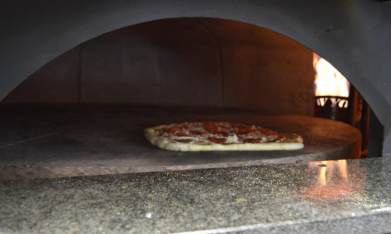 A pepperoni pizza bakes in the oven at Oysterhead Pizza Co. in downtown Damariscotta the afternoon of Friday, Oct. 11. (Maia Zewert photo)