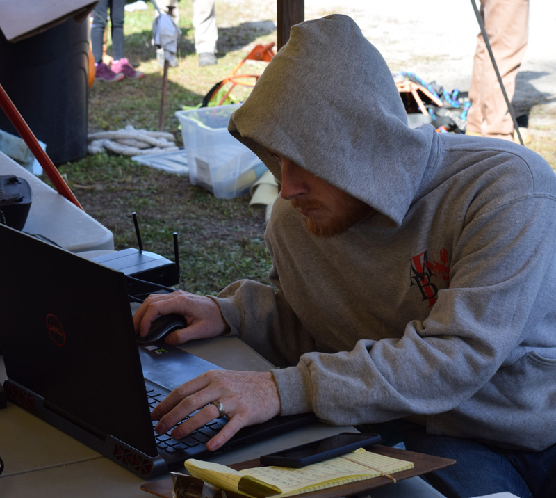 B.J. Clark, son of Damariscotta Pumpkinfest co-founder Bill Clark, works behind the scenes to tally the results at the giant pumpkin weigh-off Sunday, Oct. 6. (Evan Houk photo)